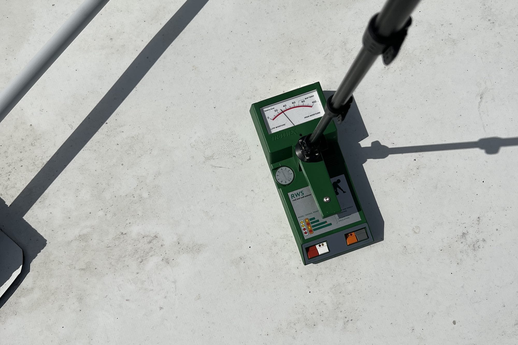 A moisture meter instrument on a commercial roof.