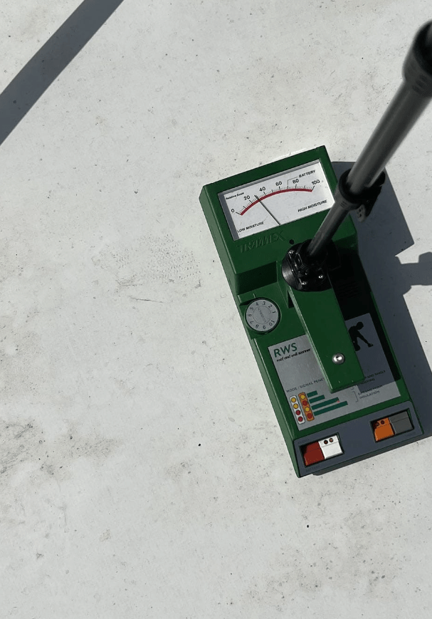 A moisture meter on a commercial roof.