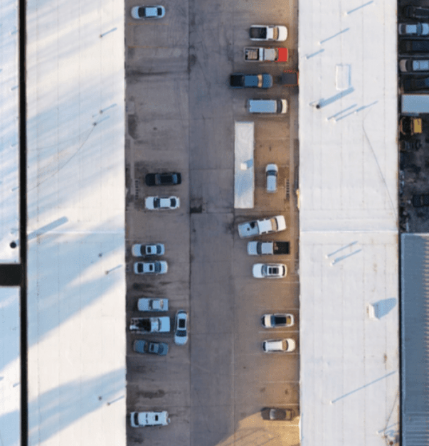 The roof and parking lot of an industrial center.